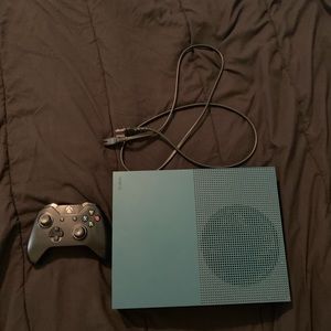 Xbox 1S with a controller, power chord, and games
